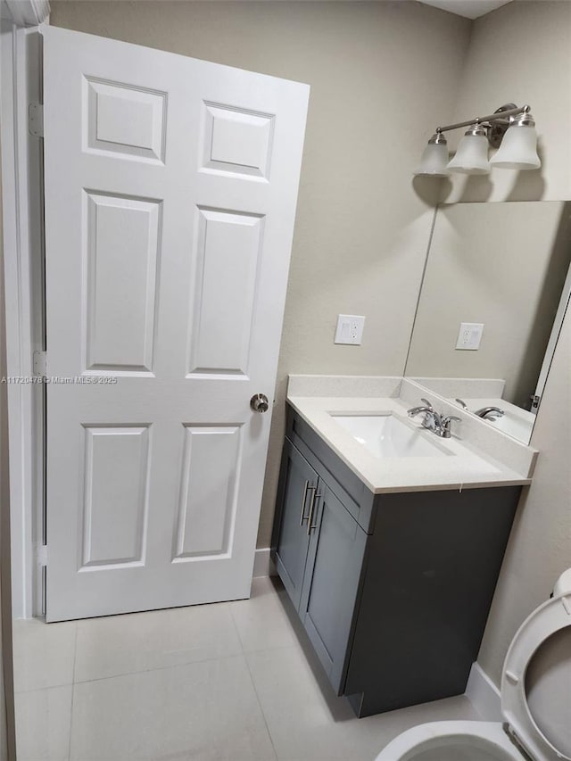 bathroom with tile patterned floors, vanity, and toilet