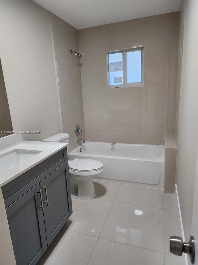 full bathroom with tile patterned flooring, vanity, toilet, and tiled shower / bath