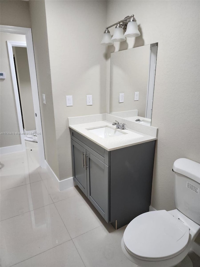 bathroom featuring tile patterned floors, vanity, and toilet