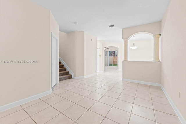 tiled spare room with ceiling fan