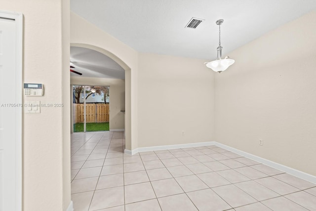 unfurnished room with ceiling fan and light tile patterned flooring