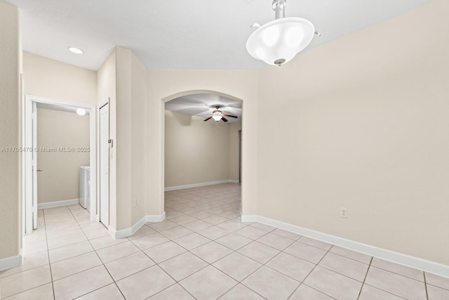 unfurnished room featuring light tile patterned floors and ceiling fan