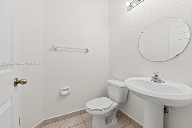 bathroom with tile patterned floors and toilet