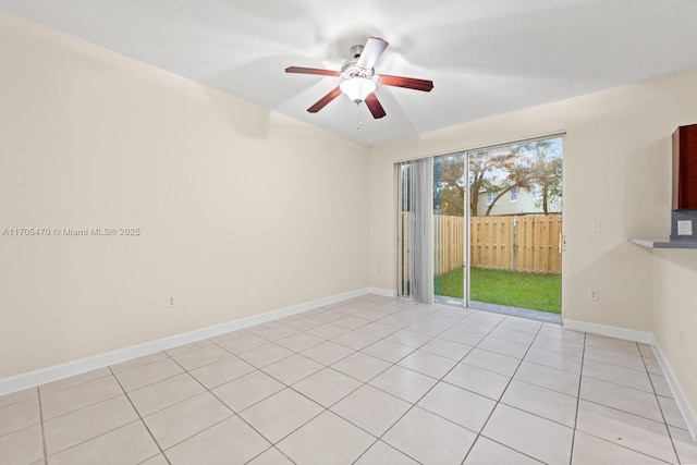 tiled spare room featuring ceiling fan