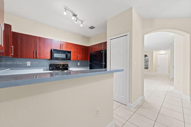 kitchen with backsplash, kitchen peninsula, light tile patterned floors, and black appliances