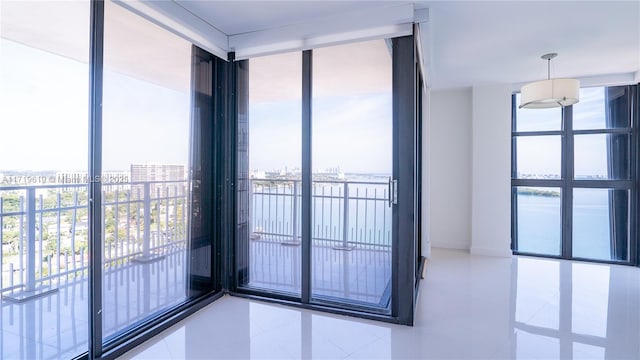 tiled empty room featuring expansive windows