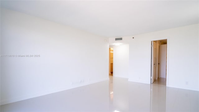 empty room featuring visible vents and baseboards