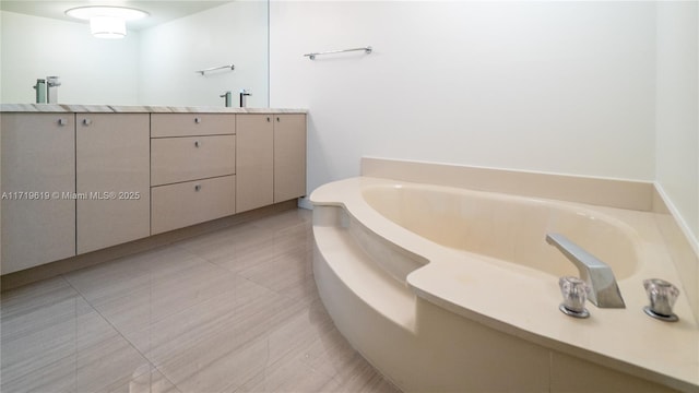 full bathroom with a sink, a bath, and double vanity