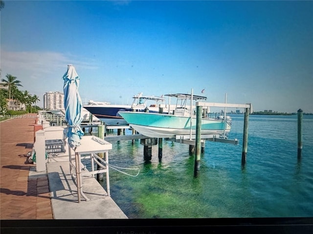 view of dock with a water view and boat lift