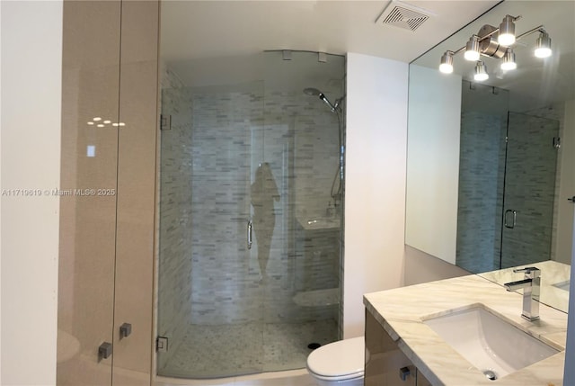 bathroom with vanity, toilet, and walk in shower