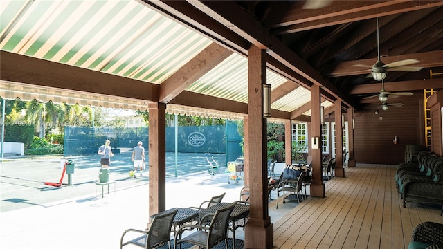 wooden terrace with fence and a ceiling fan