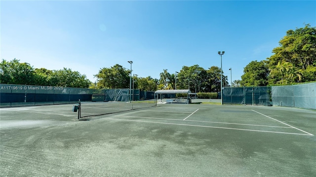 view of tennis court with fence