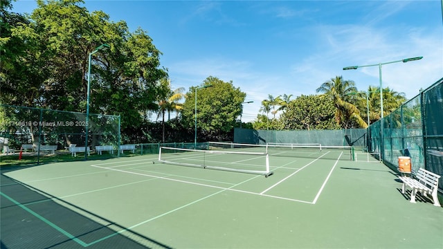 view of sport court with fence