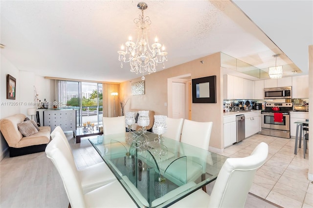 dining room featuring light tile patterned floors, a chandelier, and a textured ceiling