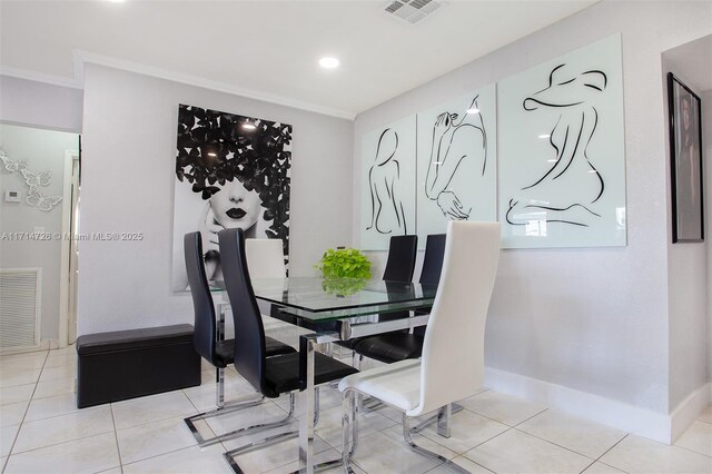 dining space with light tile patterned floors and ornamental molding