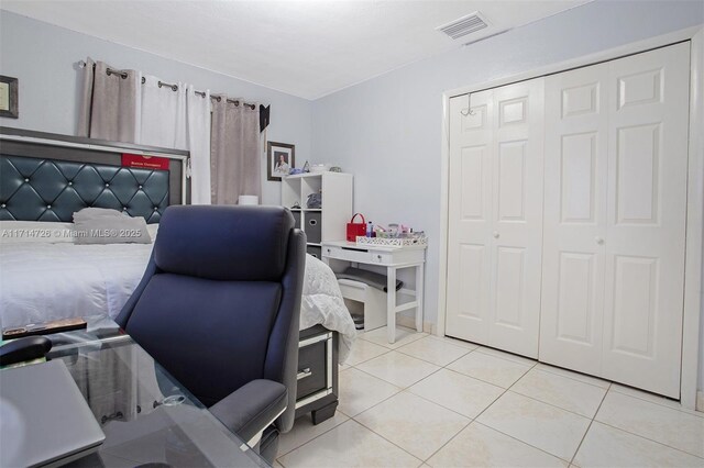 tiled bedroom featuring a closet