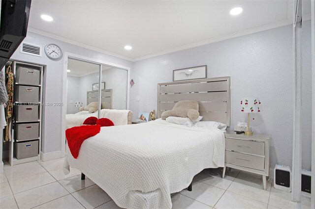 tiled bedroom featuring a closet and ornamental molding