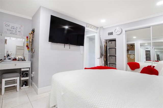 tiled bedroom featuring a closet and ornamental molding