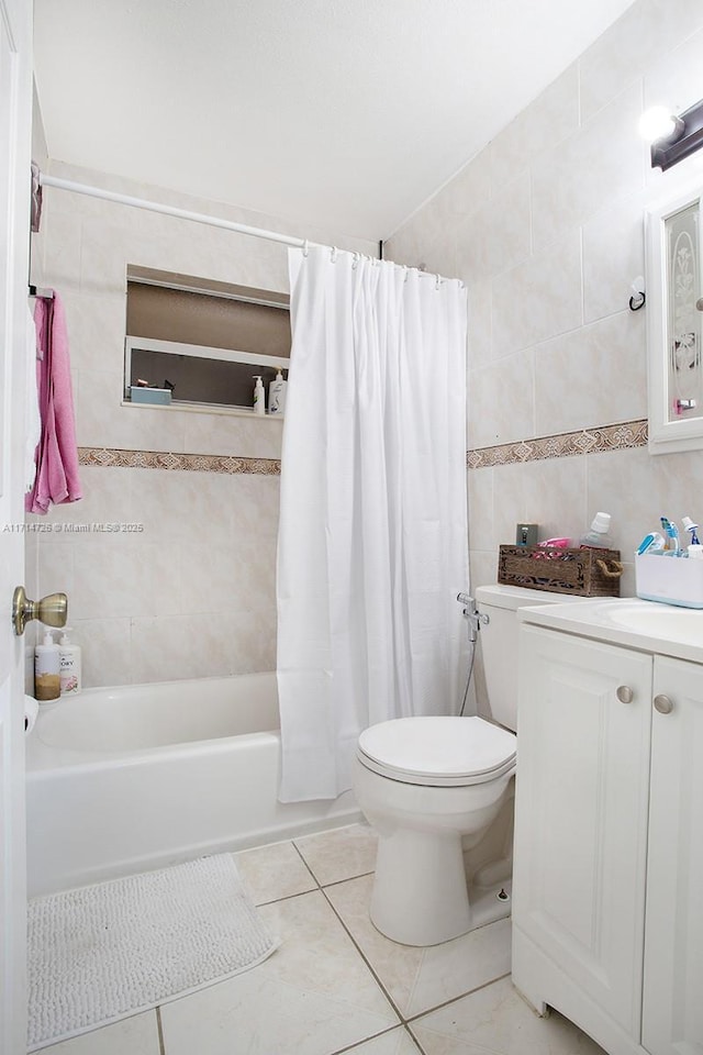 full bathroom featuring shower / bathtub combination with curtain, tile patterned floors, toilet, tile walls, and vanity