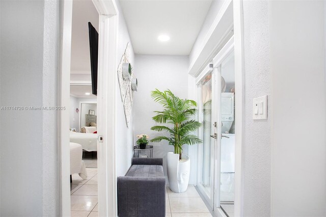 hall with light tile patterned floors