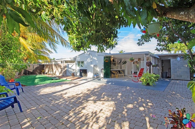 rear view of property with a lawn, a patio area, and central air condition unit