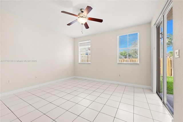 empty room with light tile patterned floors and ceiling fan