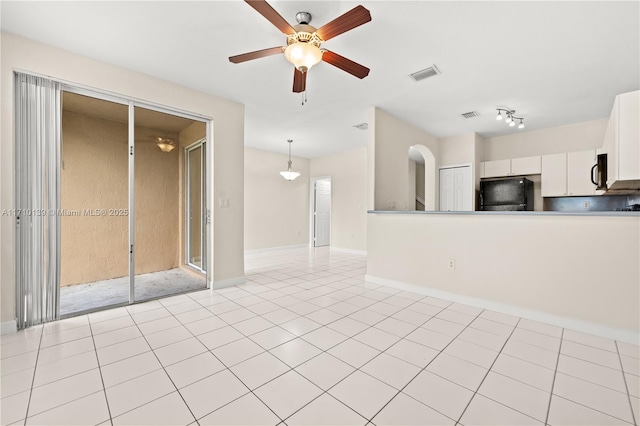 interior space featuring ceiling fan and light tile patterned floors