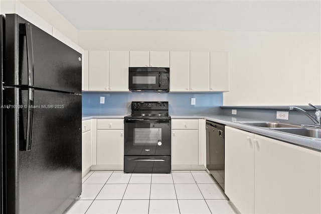 kitchen featuring white cabinets, sink, light tile patterned flooring, and black appliances