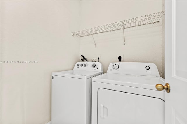 clothes washing area featuring independent washer and dryer