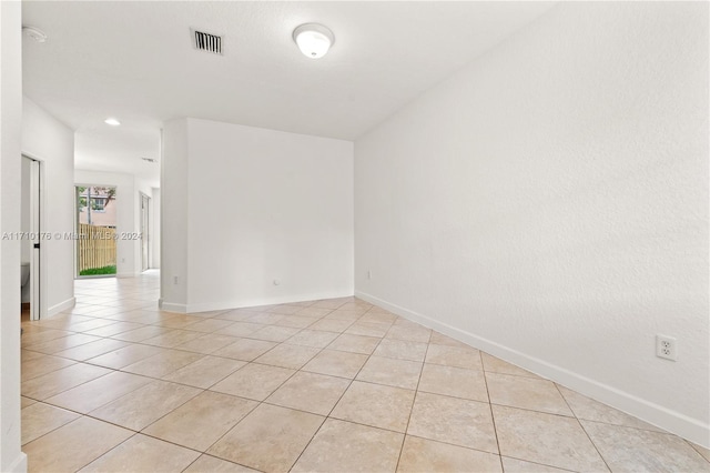 unfurnished room featuring light tile patterned floors