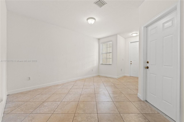 spare room featuring light tile patterned flooring