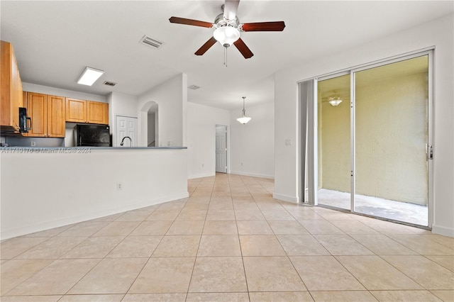 unfurnished living room with ceiling fan and light tile patterned floors