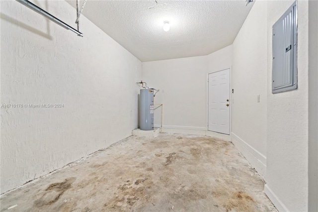 garage featuring electric panel and water heater