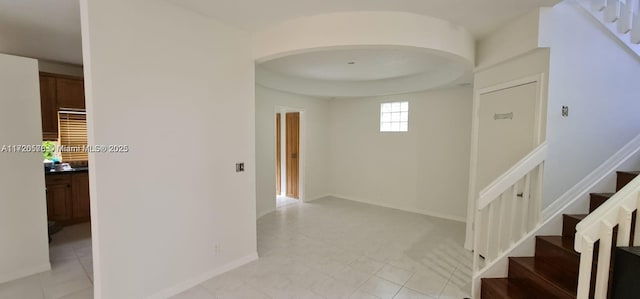 corridor featuring light tile patterned floors