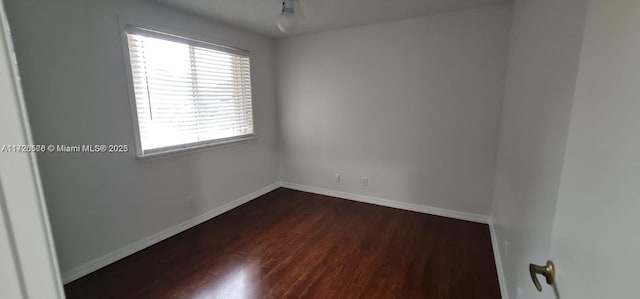 spare room featuring dark wood-type flooring