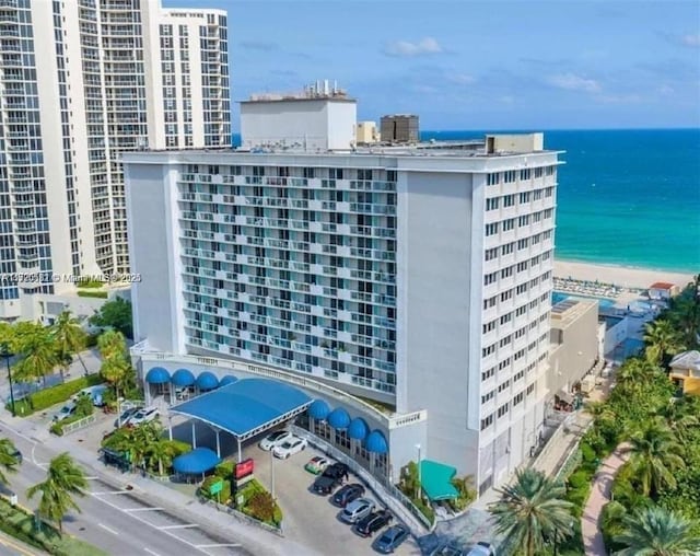 view of property with a beach view and a water view