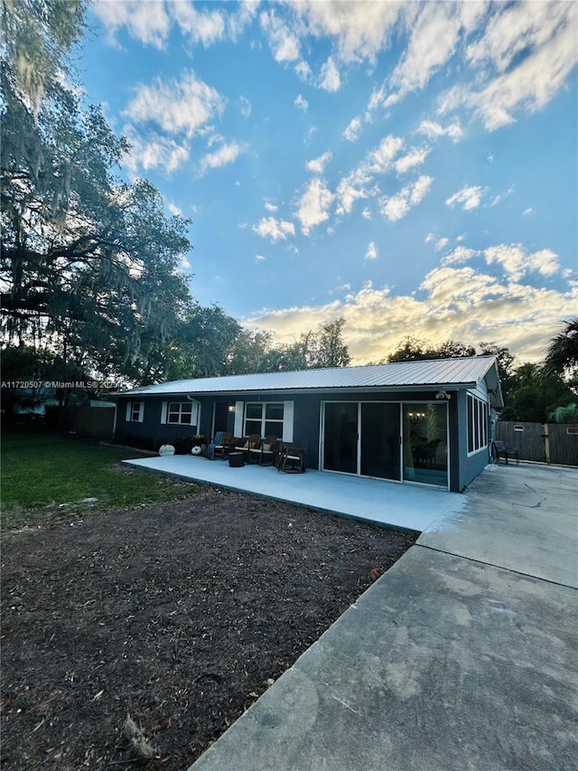 back of property with an outdoor hangout area and a patio area