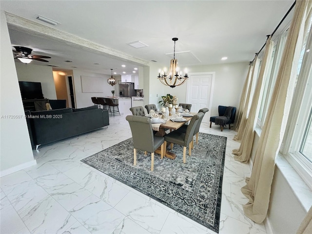 dining space with ceiling fan with notable chandelier