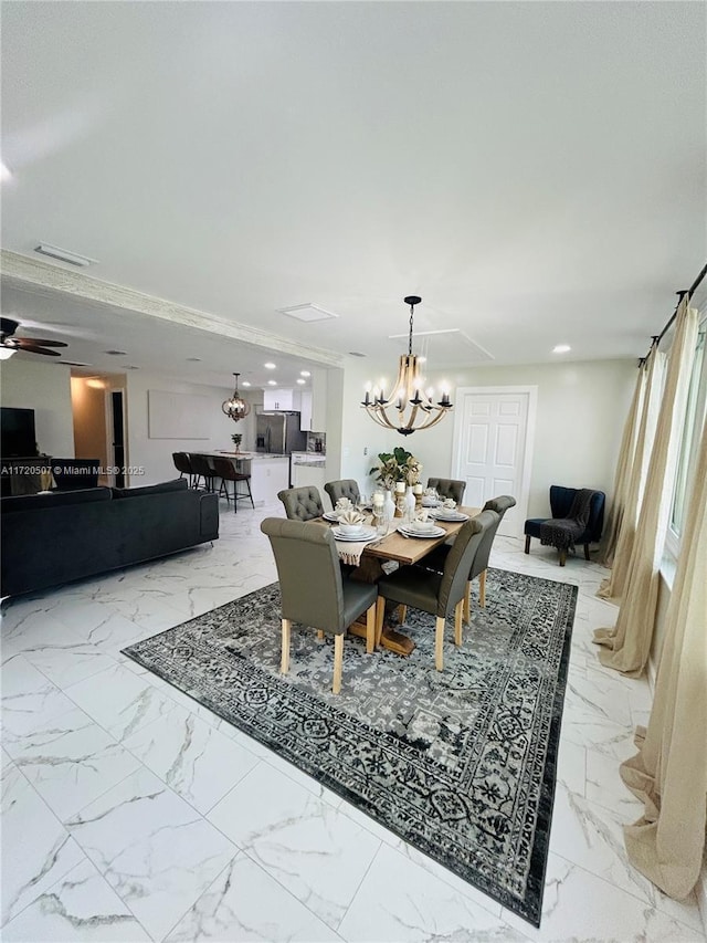 dining area featuring ceiling fan with notable chandelier