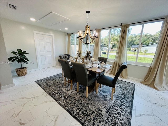 dining area with an inviting chandelier