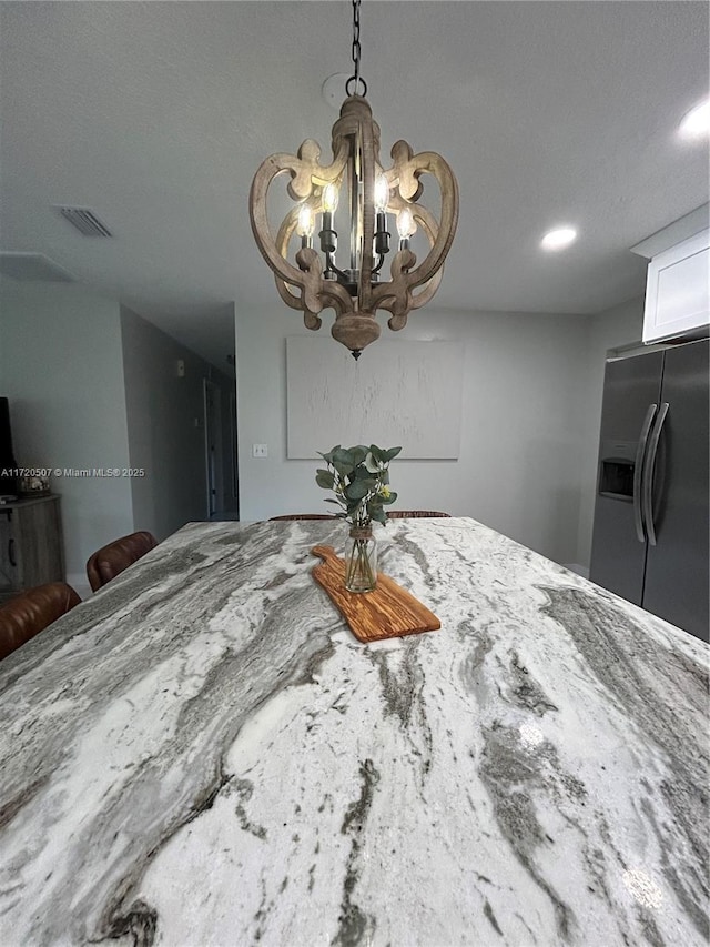 unfurnished dining area featuring a notable chandelier