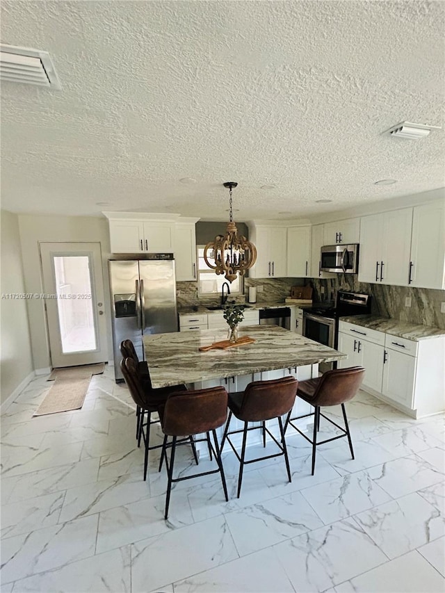 dining area featuring a notable chandelier and sink