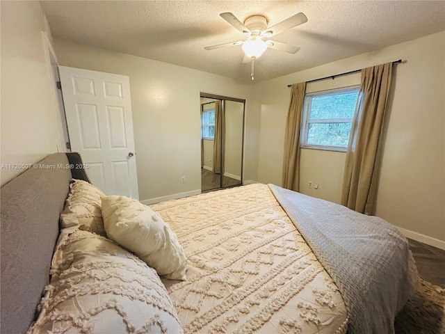 bedroom featuring a textured ceiling, a closet, and ceiling fan