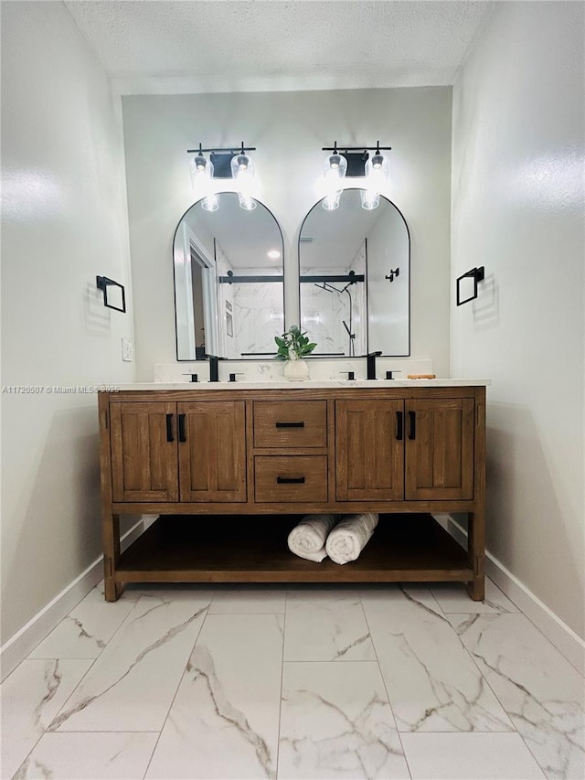 bathroom with vanity, a textured ceiling, and an enclosed shower