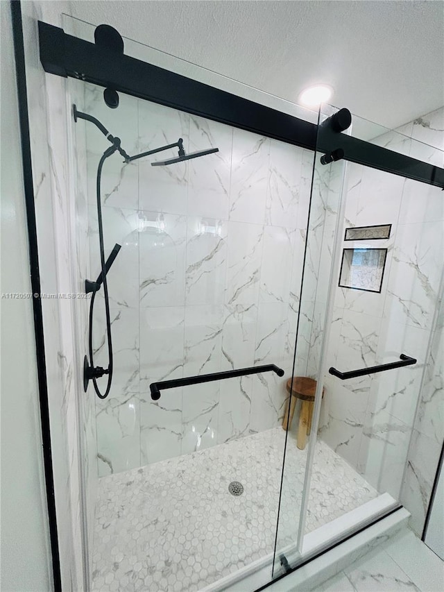 bathroom featuring a shower with door