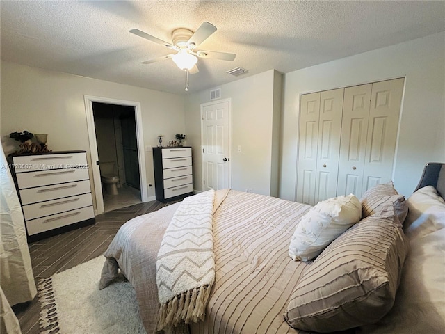 bedroom with a textured ceiling, a closet, ensuite bath, and ceiling fan