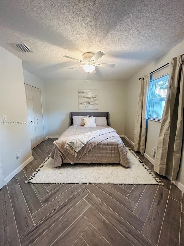 unfurnished bedroom with a textured ceiling and ceiling fan