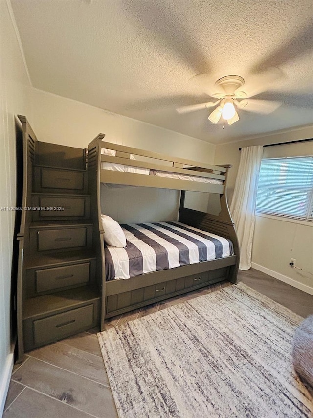 bedroom with a textured ceiling and ceiling fan