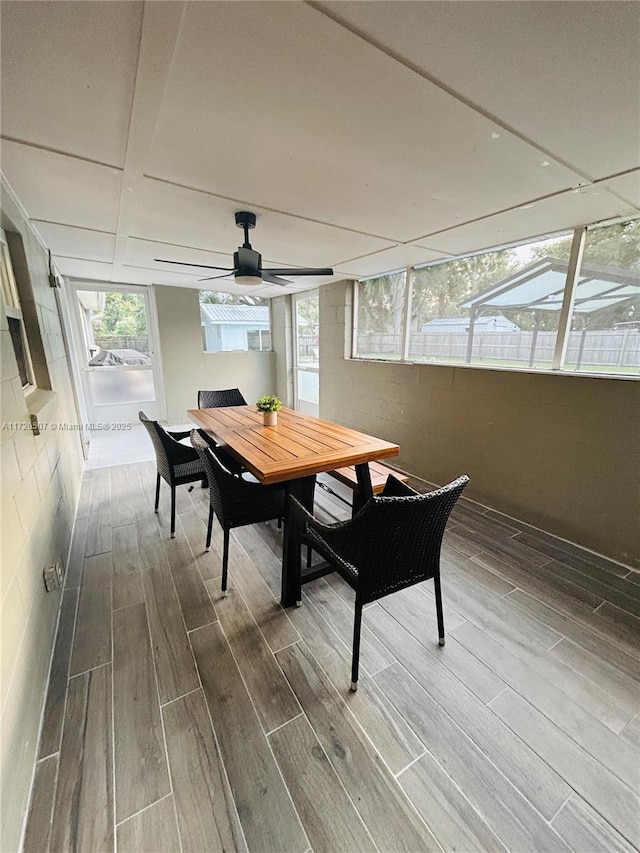 sunroom featuring ceiling fan