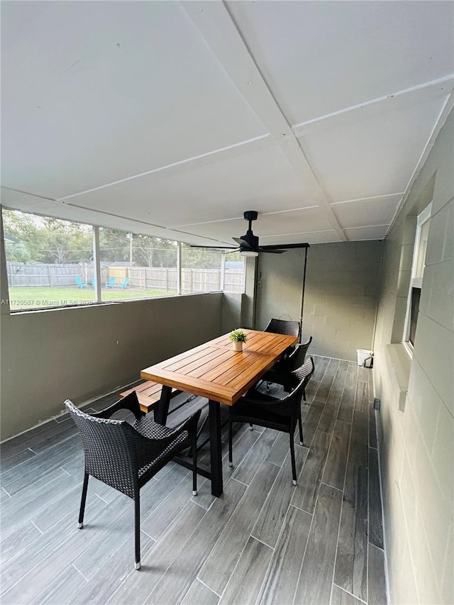 sunroom featuring ceiling fan